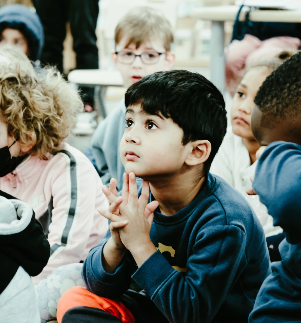 Primary-student-in-class-holding-hand